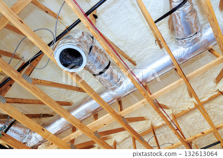 Ductwork insulation are being installed on ceiling in residential renovation project 132613064