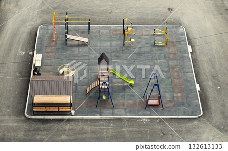 A playground with a bench and a slide A playground with a bench and a slide 132613133