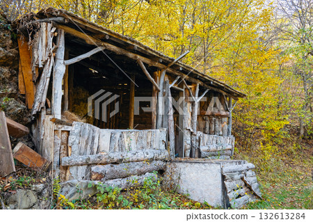 A dilapidated cabin with a wooden roof and a wooden door A dilapidated cabin with a wooden roof and a wooden door 132613284