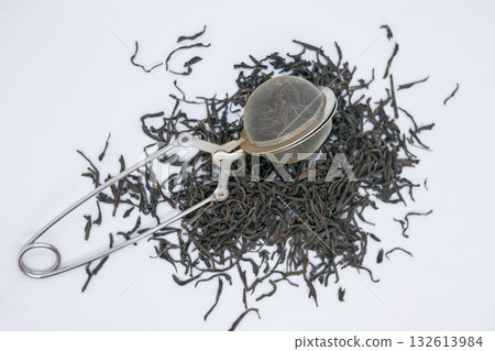Loose Leaf Black Tea with Metal Tea Infuser on White Background Loose Leaf Black Tea with Metal Tea Infuser on White Background 132613984