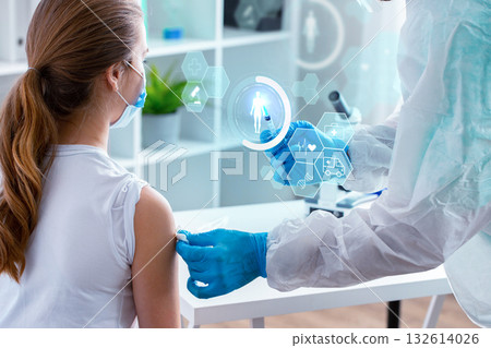 Healthcare professional administers vaccine to patient in a modern clinic setting 132614026