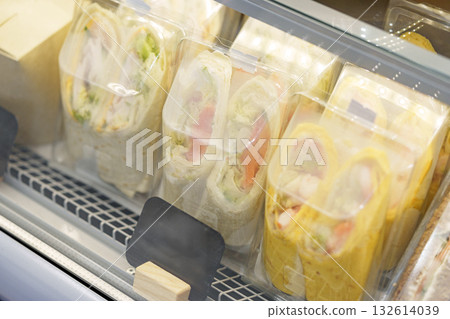 Fresh wraps displayed in a glass case at a local deli during lunchtime 132614039