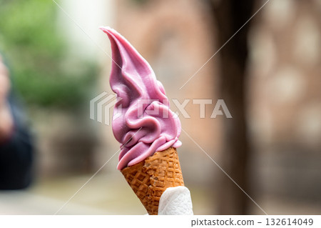 Delicious purple soft serve ice cream in a cone on a warm day Delicious purple soft serve ice cream in a cone on a warm day 132614049