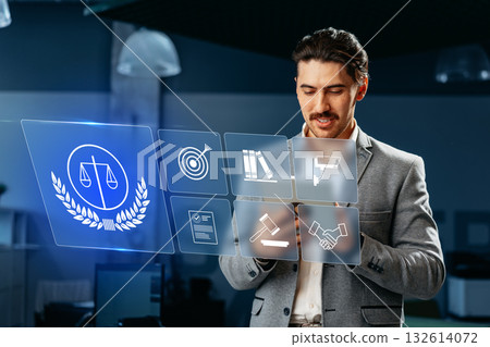 Professional man using digital law icons for modern legal practice in office setting Professional man using digital law icons for modern legal practice in office setting 132614072