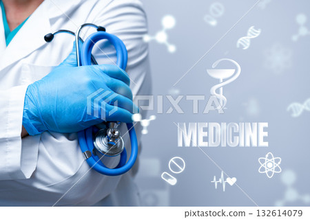 Healthcare professional holds stethoscope with medical symbols in the background 132614079