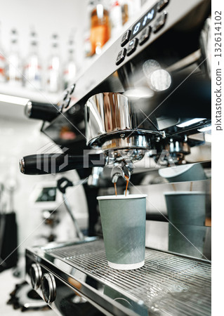 Barista prepares coffee in modern cafe during busy morning rush in urban setting Barista prepares coffee in modern cafe during busy morning rush in urban setting 132614102