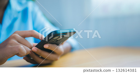 Close-up hand using smartphone for communication and business technology concept Close-up hand using smartphone for communication and business technology concept 132614381