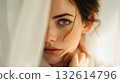 Woman gazes through sheer fabric 132614796