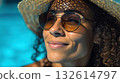 Smiling woman relaxing by the pool 132614797