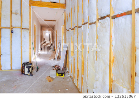 Hallway under renovation exposed insulation construction materials, indicating ongoing building work Hallway under renovation exposed insulation construction materials, indicating ongoing building work 132615067