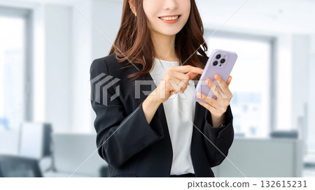 使用智慧型手機的微笑的女人/女商人 使用智慧型手機的微笑的女人/女商人 132615231