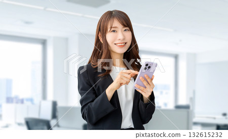 Smiling woman/businesswoman using a smartphone Smiling woman/businesswoman using a smartphone 132615232