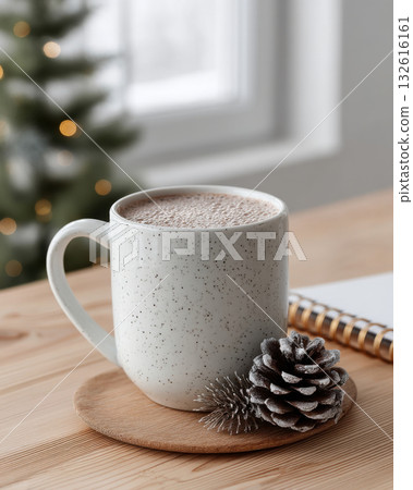 Cozy winter scene with mug of hot chocolate wooden table, accompanied by pinecone and notebook, with blurred Christmas tree 132616161