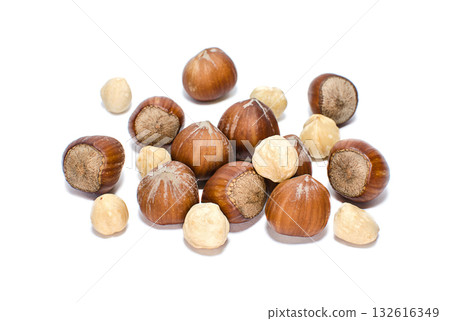 Whole and peeled hazelnuts isolated on a white background Whole and peeled hazelnuts isolated on a white background 132616349
