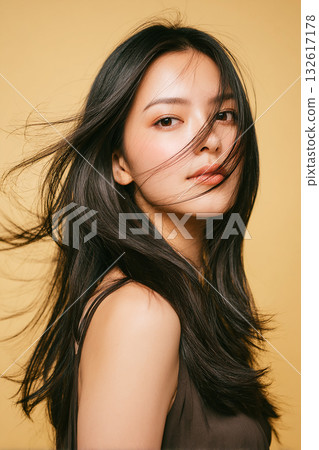 Close-up shot of a woman with long, flowing black hair Close-up shot of a woman with long, flowing black hair 132617178