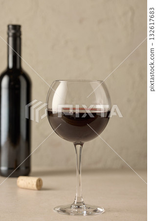closeup of red wine glass and bottle 132617683
