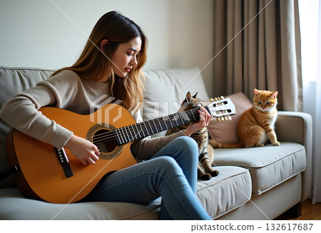 A Young Woman Playing Acoustic Guitar at Home While Relaxing with Her Pet Cat Nearby 132617687