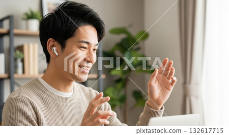 A man in an online meeting smiling and gesturing (AI-generated image) A man in an online meeting smiling and gesturing (AI-generated image) 132617715