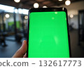 Tourist using smartphone with vertical green screen in public transport to navigate subway. Close-up of woman's hands with phone at metro station. Woman checking destination point on phone. 132617773