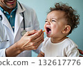 Closeup of giving vaccine to newborn baby boy from eyedropper or syringe. Concept of babies and newborn vaccination and giving vitamins. Caring parents with little children 132617776