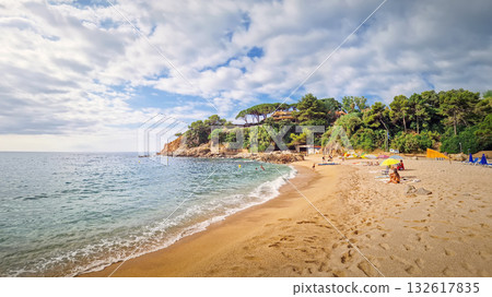 Sunny coastal panorama of Cala Bona, Sant Francesc bay in Blanes, Costa Brava, Spain. A picturesque cove famous for its golden sand, crystal-clear water, and stunning rocky cliffs with pine trees Sunny coastal panorama of Cala Bona, Sant Francesc bay in Blanes, Costa Brava, Spain. A picturesque cove famous for its golden sand, crystal-clear water, and stunning rocky cliffs with pine trees 132617835
