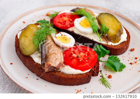 sandwiches on rye bread, with sprats, quail eggs, fresh tomatoes and pickled cucumber, appetizer, breakfast, homemade, 132617910