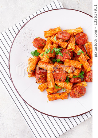rigatoni pasta with spicy sausage, and rich tomato sauce served, on a white plate, homemade, rigatoni pasta with spicy sausage, and rich tomato sauce served, on a white plate, homemade, 132617911
