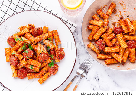 rigatoni pasta with spicy sausage, and rich tomato sauce served, on a white plate, homemade, rigatoni pasta with spicy sausage, and rich tomato sauce served, on a white plate, homemade, 132617912