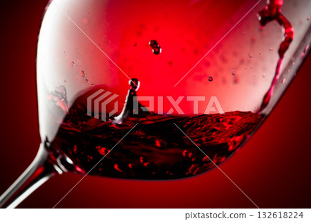 Red wine is poured into a glass. 132618224