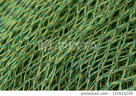 Stacked fishing nets in various colors and textures create a composition of maritime life. Stacked fishing nets in various colors and textures create a composition of maritime life. 132618299