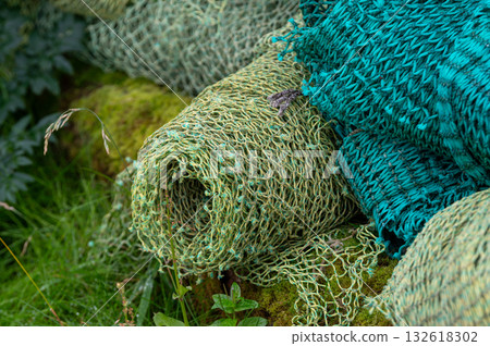 Stacked fishing nets in various colors and textures create a nice, vibrant, detailed composition of maritime life. 132618302
