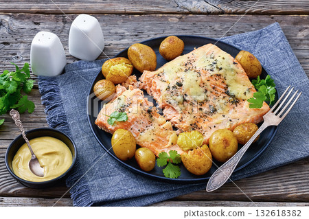 Salmon fillet with cheese, spices, baby potatoes 132618382