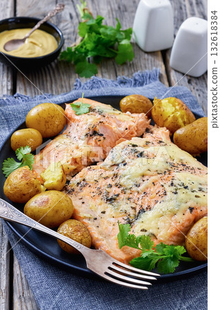 Salmon fillet with cheese, spices, baby potatoes Salmon fillet with cheese, spices, baby potatoes 132618384