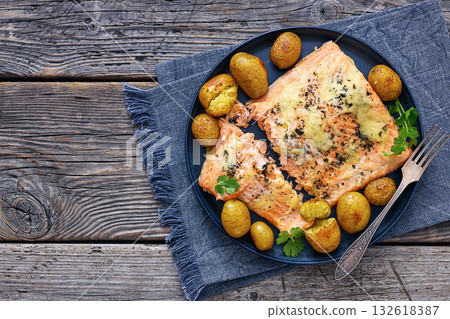 Salmon fillet with cheese, spices, baby potatoes 132618387