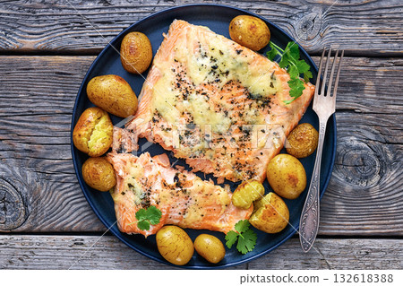 Salmon fillet with cheese, spices, baby potatoes Salmon fillet with cheese, spices, baby potatoes 132618388