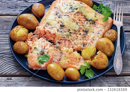 Salmon fillet with cheese, spices, baby potatoes 132618389