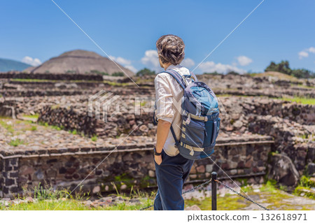 Male tourist posing in front of the pyramids of Teotihuacan in Mexico, enjoying sightseeing, cultural heritage, and travel adventure Male tourist posing in front of the pyramids of Teotihuacan in Mexico, enjoying sightseeing, cultural heritage, and travel adventure 132618971