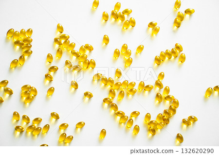 Scattered omega capsules on bright white background with soft light Scattered omega capsules on bright white background with soft light 132620290