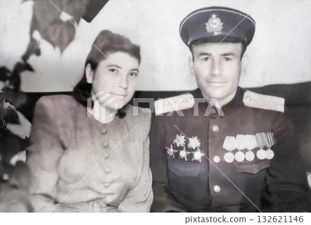Vintage portrait of a family of World War II veterans. Man and woman with medals and orders. Retro photo 11.27.1947 132621146