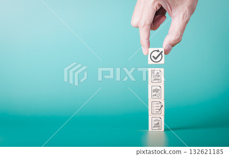 Document review process and quality control concept. Hand placing checkmark. wooden blocks document icons, symbolizing document verification, business approval process, certificate management, audit, 132621185