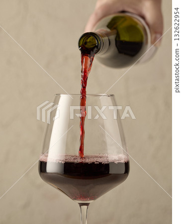 closeup of red wine pouring in glass closeup of red wine pouring in glass 132622954