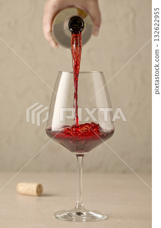 closeup of red wine pouring in glass closeup of red wine pouring in glass 132622955
