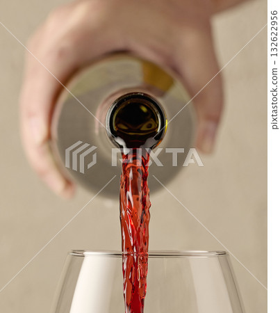 closeup of red wine pouring in glass 132622956