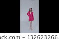 Fashion model wearing pink blazer and white high heels, standing confidently in sleek studio setting with minimalist white background 132623266