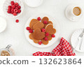 A heap of heart shaped pancakes on the white plate with raspberries on the white background 132623864