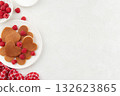 A heap of heart shaped pancakes on the white plate with raspberries on the white background 132623865