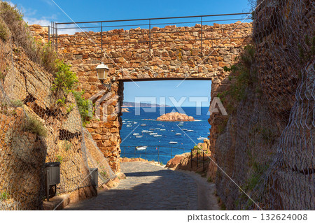 Stone archway and sea view in Tossa de Mar Spain 132624008