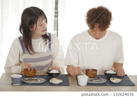 A happy young couple having a meal A happy young couple having a meal 132624016