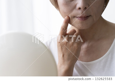 Senior woman worried about facial aging Senior woman worried about facial aging 132625583