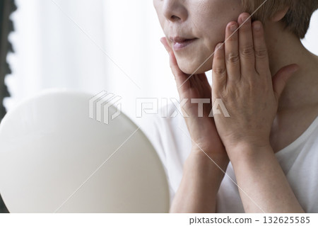 Senior woman worried about facial aging Senior woman worried about facial aging 132625585